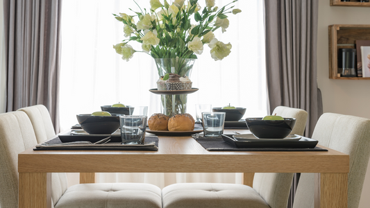 A rectangular wooden dining table takes center stage, radiating warmth and elegance.