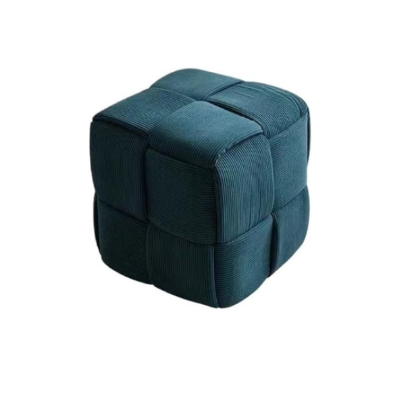 Dark teal corduroy ottoman with sturdy wood frame and unique textured design for home decor.