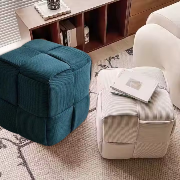 Dark teal corduroy ottoman with sturdy wood frame and unique textured design for home decor.