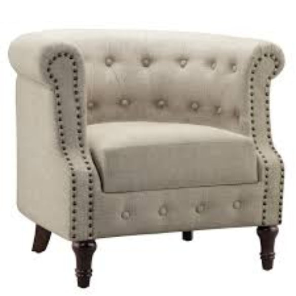 A warm beige mid-century modern accent chair with hand-pulled tufted buttons, silver-toned nailhead accents, and turned wooden legs. The chair features a plush, ergonomic design with foam cushioning and a tufted back for added texture and sophistication. The solid rubberwood frame and durable upholstery ensure long-lasting comfort and support, making it perfect for various rooms including the living room, office, or bedroom.