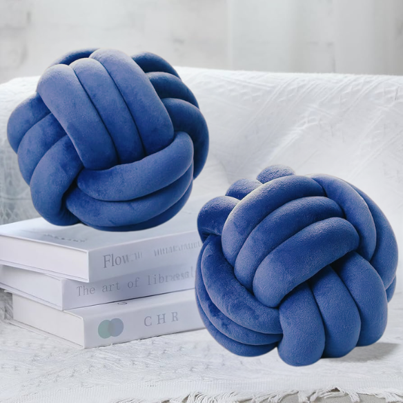 Close-up of blue accent pillow featuring a soft, raised geometric pattern. Stylish cushion for living room or bedroom.