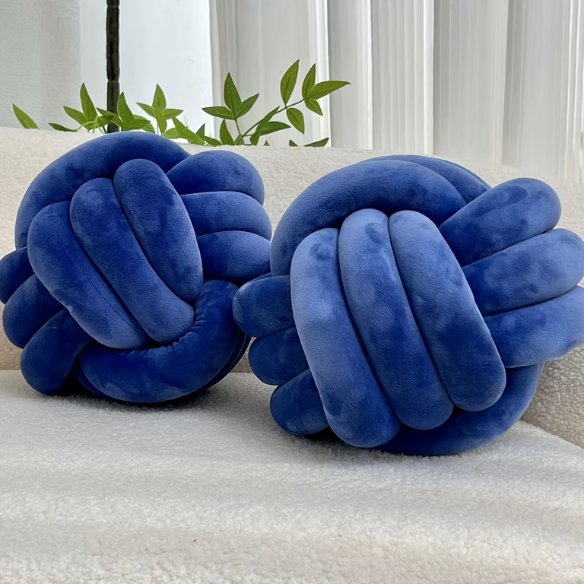 Close-up of blue accent pillow featuring a soft, raised geometric pattern. Stylish cushion for living room or bedroom.