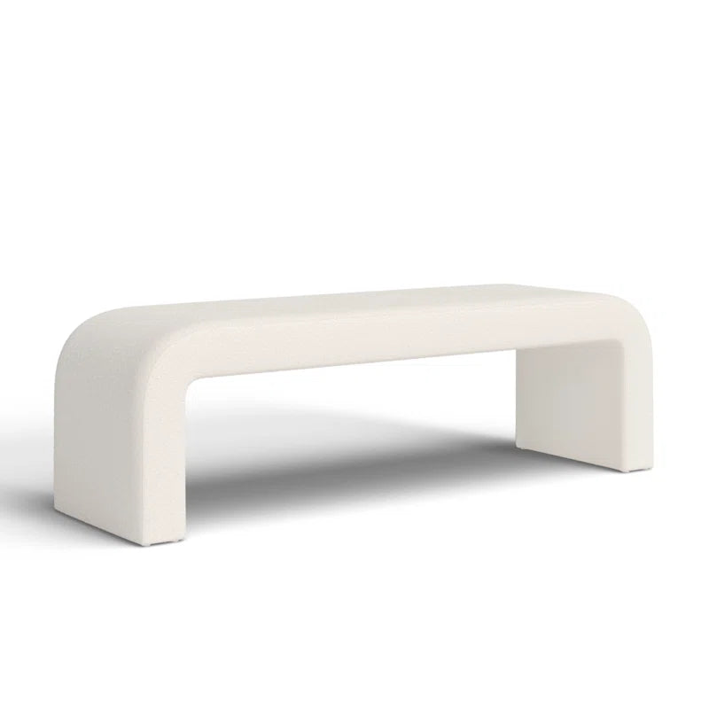 Luxurious cream bouclé ottoman with plush foam cushioning, versatile storage, and sleek sled legs, perfect for enhancing bedroom decor or any room. Premium construction, easy care, and a 500 lb weight capacity for ultimate comfort and style.