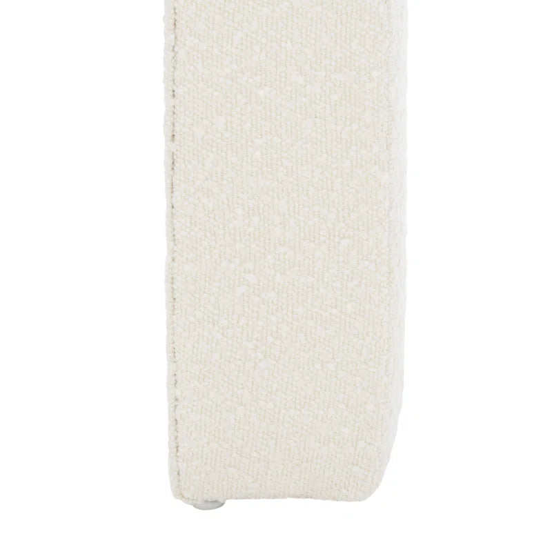 Luxurious cream bouclé ottoman with plush foam cushioning, versatile storage, and sleek sled legs, perfect for enhancing bedroom decor or any room. Premium construction, easy care, and a 500 lb weight capacity for ultimate comfort and style.