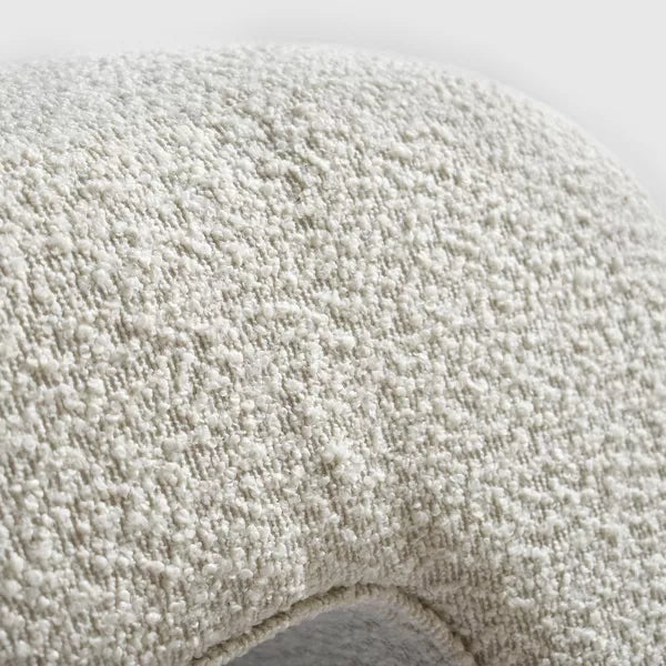 Luxurious cream bouclé ottoman with plush foam cushioning, versatile storage, and sleek sled legs, perfect for enhancing bedroom decor or any room. Premium construction, easy care, and a 500 lb weight capacity for ultimate comfort and style.