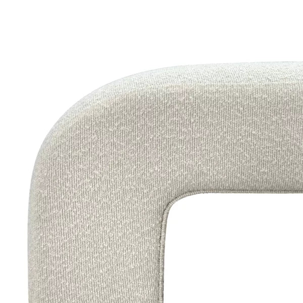 Luxurious cream bouclé ottoman with plush foam cushioning, versatile storage, and sleek sled legs, perfect for enhancing bedroom decor or any room. Premium construction, easy care, and a 500 lb weight capacity for ultimate comfort and style.
