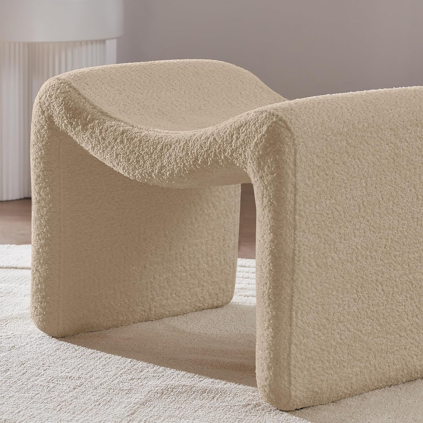 Modern camel-colored pedal stool with engineered wood frame, smooth lint and sherpa lining, versatile semicircular design, and compact size. Ideal as a footrest, extra seating, or accent piece for any room.