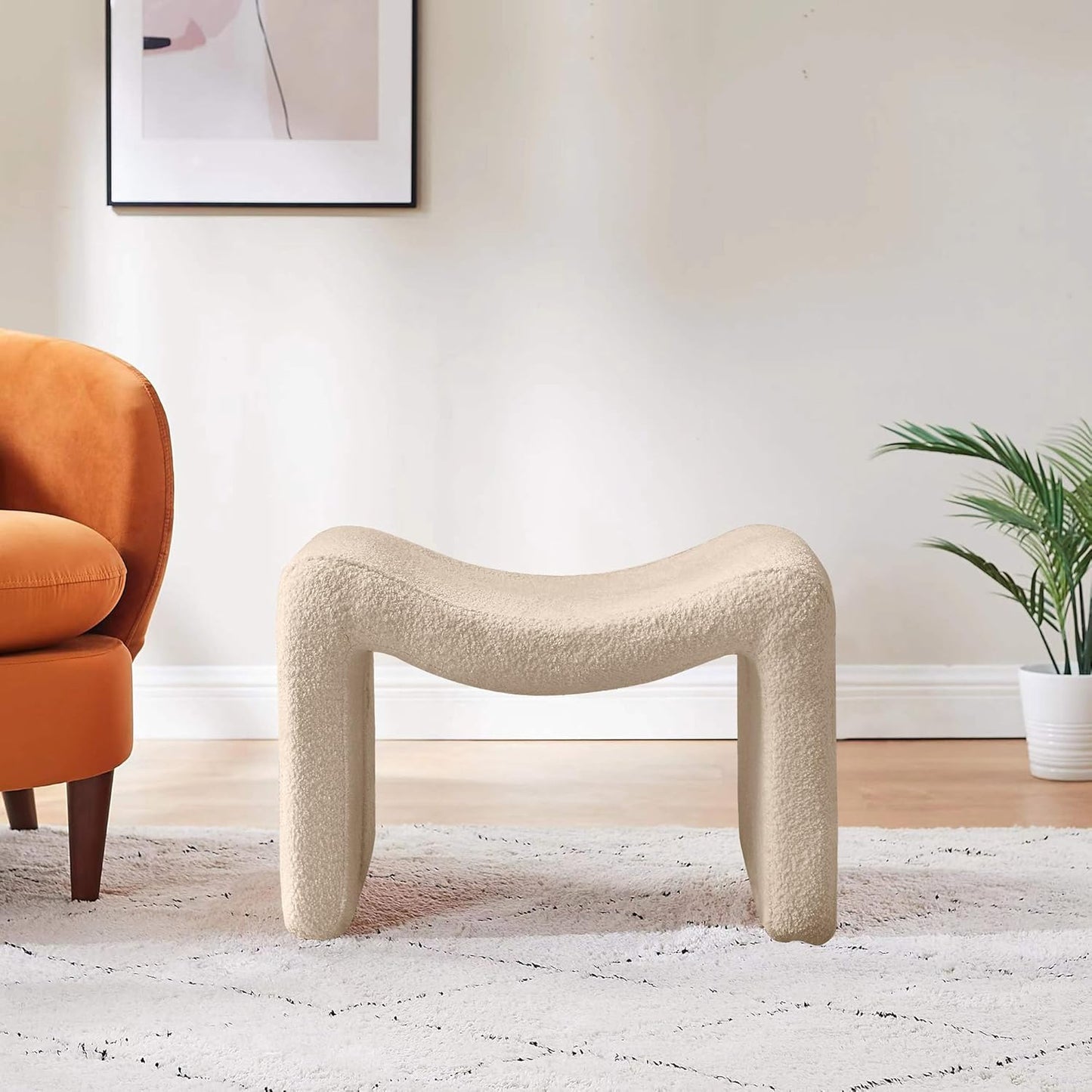 Modern camel-colored pedal stool with engineered wood frame, smooth lint and sherpa lining, versatile semicircular design, and compact size. Ideal as a footrest, extra seating, or accent piece for any room.