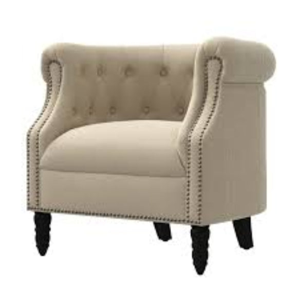 A warm beige mid-century modern accent chair with hand-pulled tufted buttons, silver-toned nailhead accents, and turned wooden legs. The chair features a plush, ergonomic design with foam cushioning and a tufted back for added texture and sophistication. The solid rubberwood frame and durable upholstery ensure long-lasting comfort and support, making it perfect for various rooms including the living room, office, or bedroom.