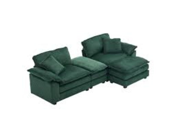 Modern emerald green ribbed velvet corduroy sofa with foam cushioning and pocket spring system, featuring a sturdy wood frame, plush back pillows, and sleek black plastic legs for superior comfort and stylish design.