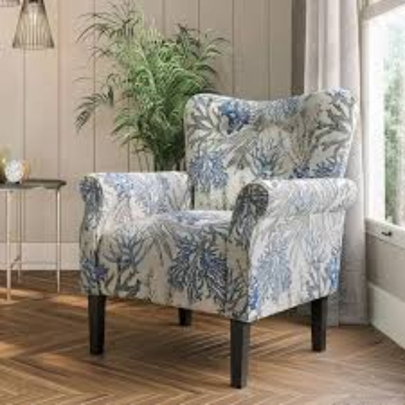 A stylish Blue Coral Accent Chair featuring a vibrant blue coral fabric with a unique pattern. The chair has a tufted wingback design, gracefully tapered wood legs, and padded armrests for optimal comfort. It combines modern sophistication with a classic aesthetic, ideal for any living room, office, or reading nook.