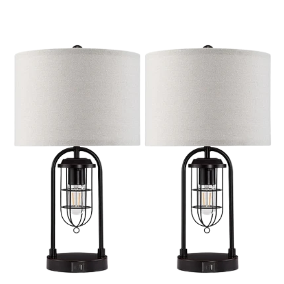 Set of two 21.5-inch espresso table lamps with arch-shaped metal bases, beige fabric drum shades, built-in USB-A and USB-C charging ports, and lantern-style night lights — ideal for modern, industrial, or transitional interiors.