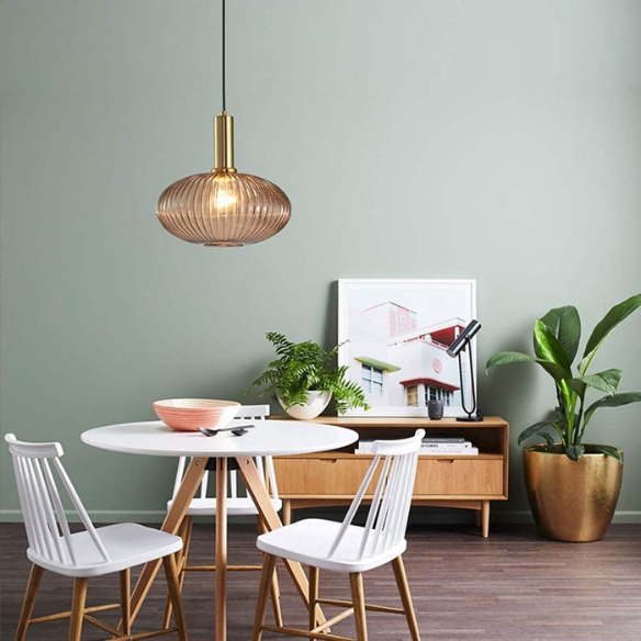 Modern amber glass pendant light with black metal frame and gold accent finishes – industrial chandelier design for dining room, kitchen, or living room.