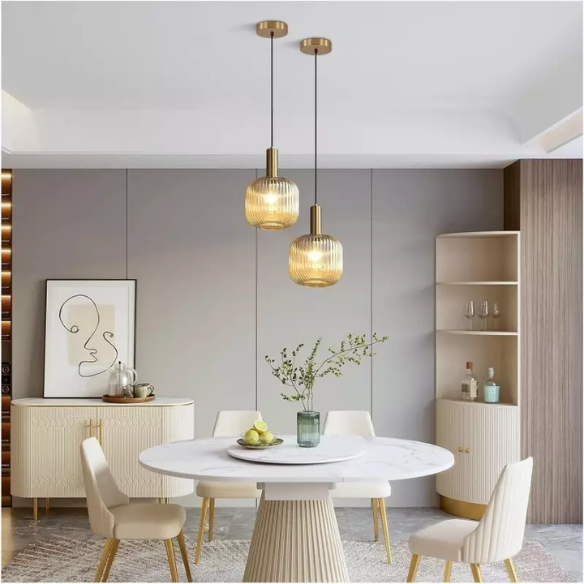 Amber glass pendant light with gold accent finishes, modern ceiling fixture for kitchen island, dining room, and bedroom.