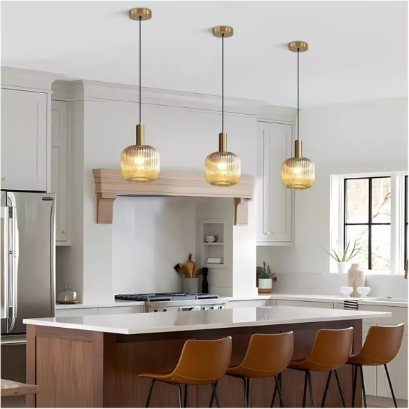 Amber glass pendant light with gold accent finishes, modern ceiling fixture for kitchen island, dining room, and bedroom.