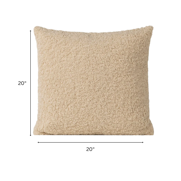Beige bouclé throw pillow with looped textured fabric, square accent pillow on a neutral-toned sofa