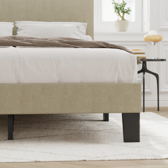 Beige king-size upholstered platform bed with adjustable linen headboard, underbed storage clearance, and padded frame for modern bedroom décor