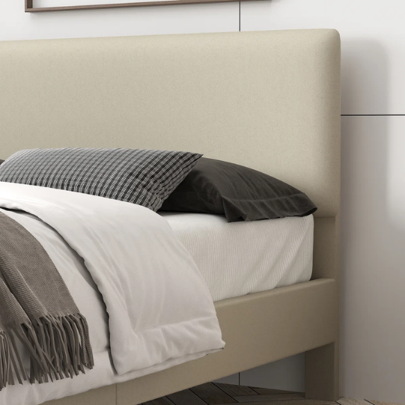 Beige king-size upholstered platform bed with adjustable linen headboard, underbed storage clearance, and padded frame for modern bedroom décor