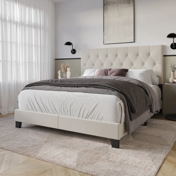 Beige linen full size upholstered bed with button tufted headboard and low-profile legs