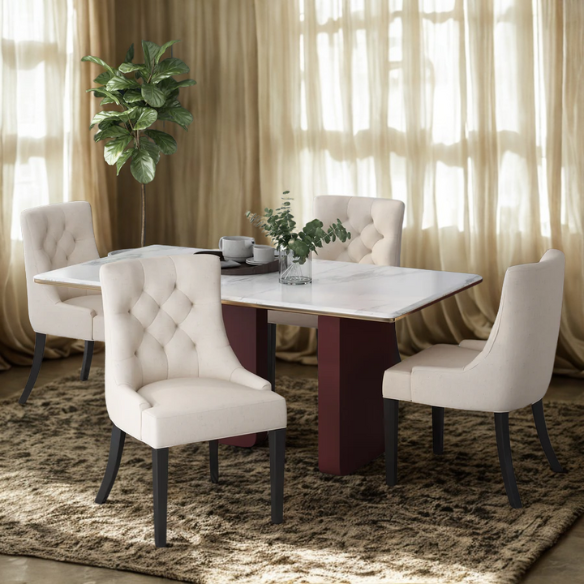 Set of four beige upholstered dining chairs featuring diamond tufting, armless design, sloped sides, and espresso brown wooden legs.