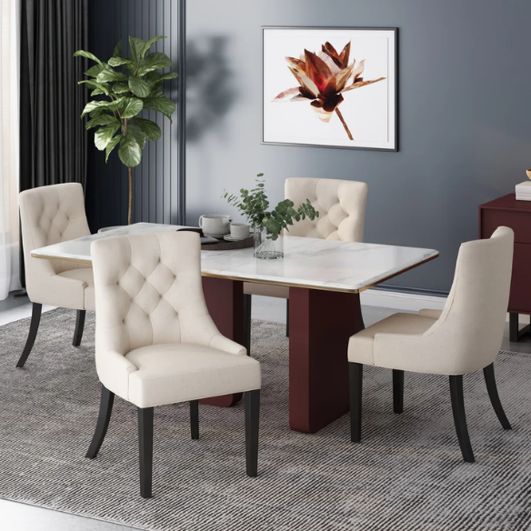 Set of four beige upholstered dining chairs featuring diamond tufting, armless design, sloped sides, and espresso brown wooden legs.