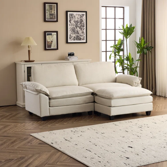 Beige modular cloud sofa with pillow top arms, deep foam cushions, and matching ottoman