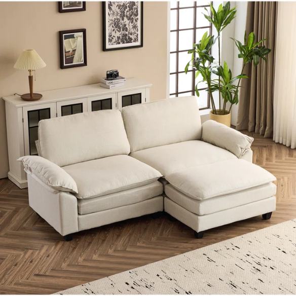 Beige modular cloud sofa with pillow top arms, deep foam cushions, and matching ottoman