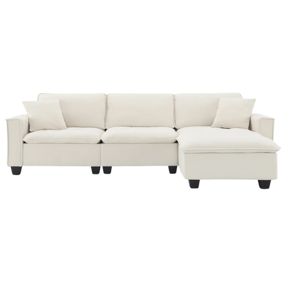 Beige suede L-shaped sectional sofa with removable ottoman, tufted seat cushions, and two matching accent pillows