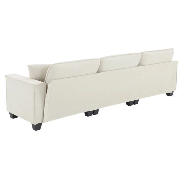 Beige suede L-shaped sectional sofa with removable ottoman, tufted seat cushions, and two matching accent pillows