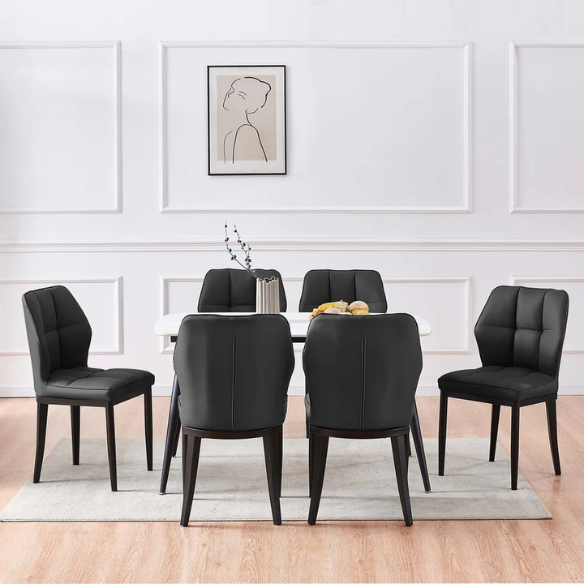 Set of two mid-century modern black faux leather dining chairs with checkered stitching and metal legs
