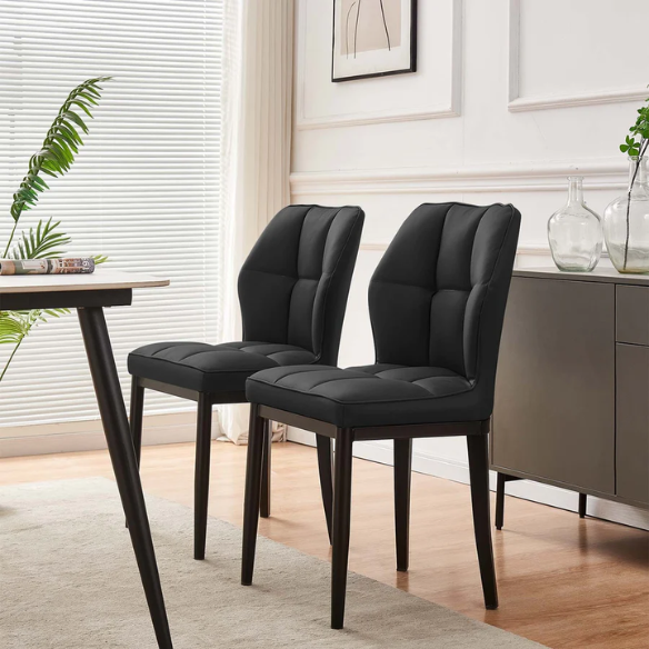 Set of two mid-century modern black faux leather dining chairs with checkered stitching and metal legs