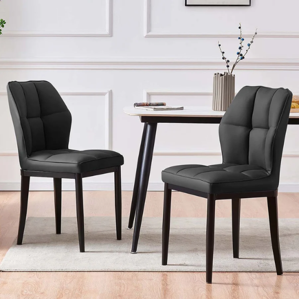 Set of two mid-century modern black faux leather dining chairs with checkered stitching and metal legs