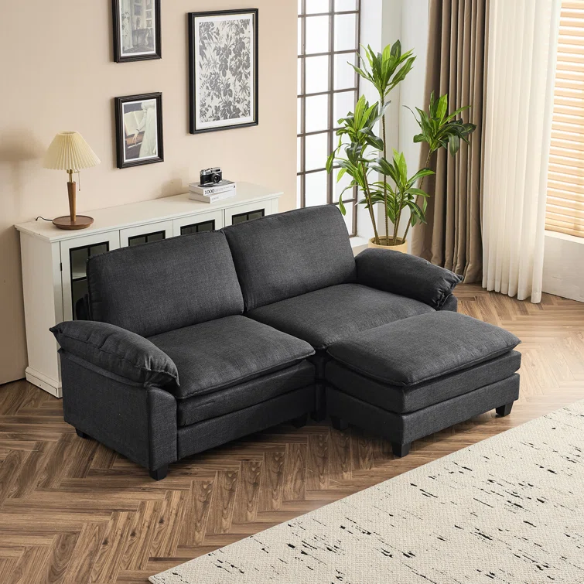 Black modular cloud sofa with deep foam cushions, pillow top arms, and matching ottoman