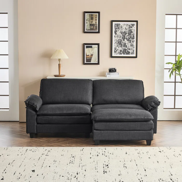 Black modular cloud sofa with deep foam cushions, pillow top arms, and matching ottoman