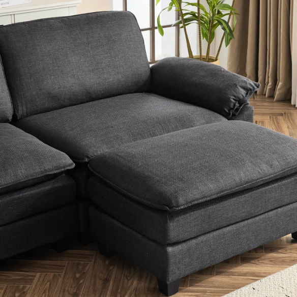 Black modular cloud sofa with deep foam cushions, pillow top arms, and matching ottoman