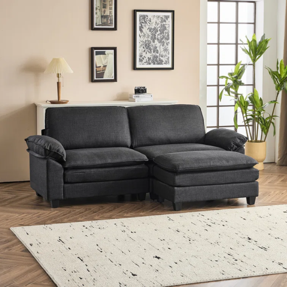 Black modular cloud sofa with deep foam cushions, pillow top arms, and matching ottoman