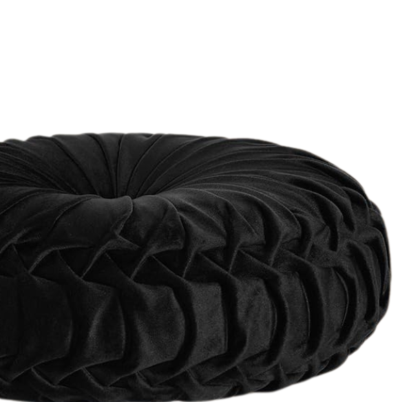 Black velvet round throw pillows with hand-sewn pleats and central button, set of two 14.5-inch plush decorative cushions styled on a modern neutral sofa.