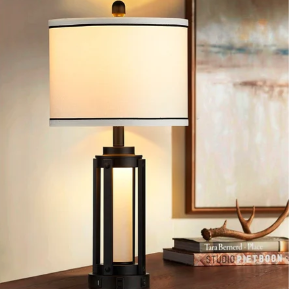 Set of two 25.3-inch modern black table lamps featuring white drum shades with black trim, built-in nightlight, USB and Type-C charging ports, and AC outlet on each base.