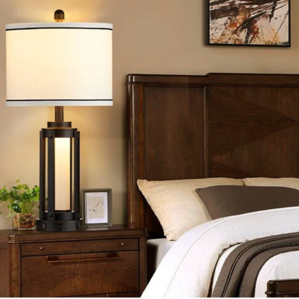 Set of two 25.3-inch modern black table lamps featuring white drum shades with black trim, built-in nightlight, USB and Type-C charging ports, and AC outlet on each base.