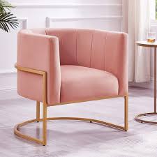 Blush pink velvet barrel accent chair with a U-shaped cantilever gold base, featuring foam-filled seat and back for comfort, and chic channel tufting for added texture. Elegant Art Deco-inspired design with solid wood and stainless steel frame for durability.
