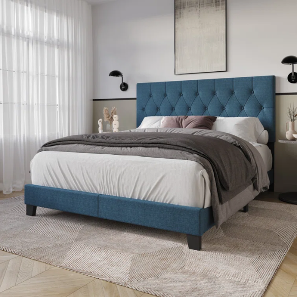 Blue linen full size upholstered bed with button tufted headboard and low-profile legs