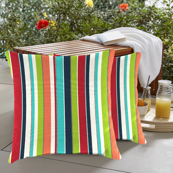 Striped accent pillow in blue, red, white, green, and black – reversible, weather-resistant, and overstuffed with plush polyester fill for indoor and outdoor use on patios, decks, or couches.