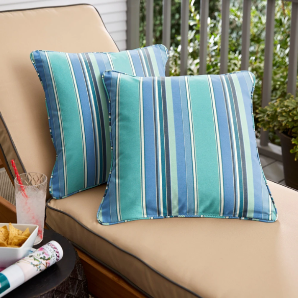 Blue, teal, and white striped accent pillow – reversible, weather-resistant, and overstuffed for comfort; perfect for indoor or outdoor use on patios, decks, or living spaces.