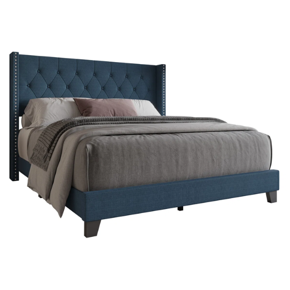 Blue upholstered full-size bed with tufted wingback headboard and nailhead trim