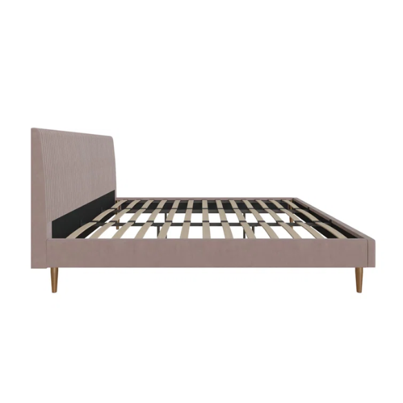 Blush pink velvet upholstered king-size platform bed with padded rectangular headboard, solid wood slats, and elegant low-profile frame.