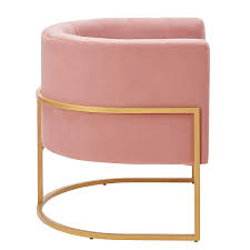 Blush pink velvet barrel accent chair with a U-shaped cantilever gold base, featuring foam-filled seat and back for comfort, and chic channel tufting for added texture. Elegant Art Deco-inspired design with solid wood and stainless steel frame for durability.