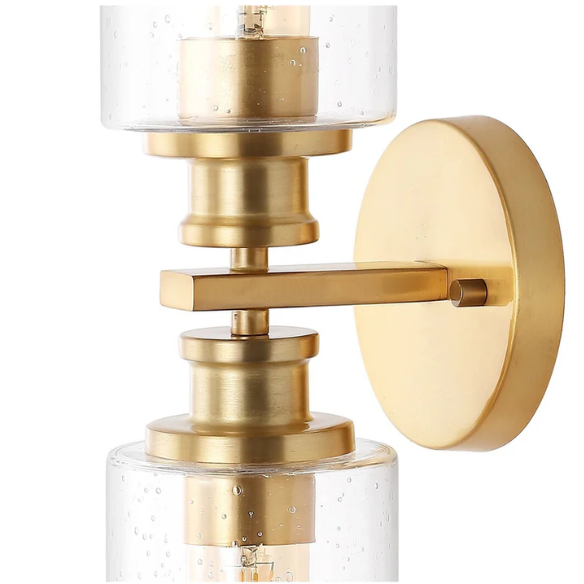 Rich brass wall sconce with dual clear seeded glass cylinder shades and Edison-style LED bulbs, perfect for upscale bathroom or hallway lighting
