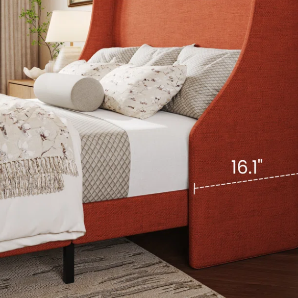 Burnt orange upholstered queen platform bed with wingback headboard, tapered legs, and slatted base – no box spring required