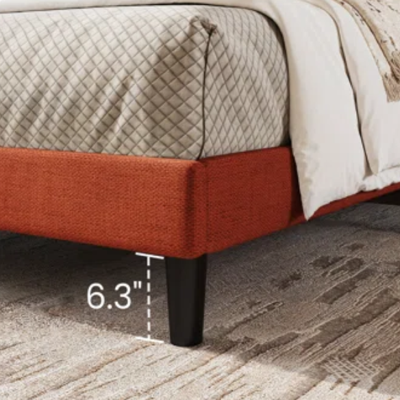 Burnt orange upholstered queen platform bed with wingback headboard, tapered legs, and slatted base – no box spring required