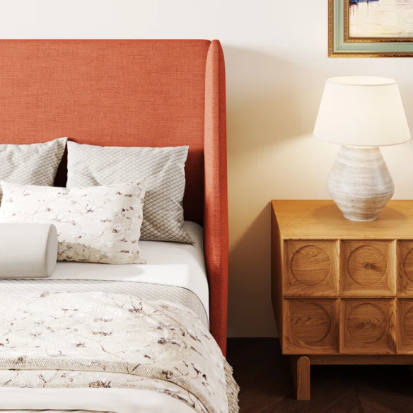 Burnt orange upholstered queen platform bed with wingback headboard, tapered legs, and slatted base – no box spring required
